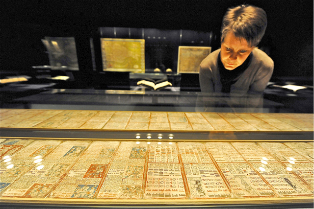 Eine Ausstellungsbesucherin betrachtet in der Schatzkammer im Buchmuseum in Dresden eine im 13. Jahrhundert entstandene Handschrift der Maya. Diese Handschrift mit der vermeintlichen Prophezeiung des Weltuntergangs sorgt zurzeit für einen Besucheransturm in der Sächsischen Landesbibliothek. Foto: dapd