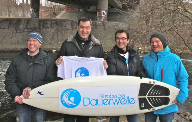 Bayerns Finanzminister Markus Söder (2.v.l.) mit Organisator Stefan Bachschmid (l.), Roland Amon (2.v.r.) und 1. Vorsitzender Michael Heitz vom Surfverein unter der Theodor-Heuss-Brücke. Foto: Udo Dreier