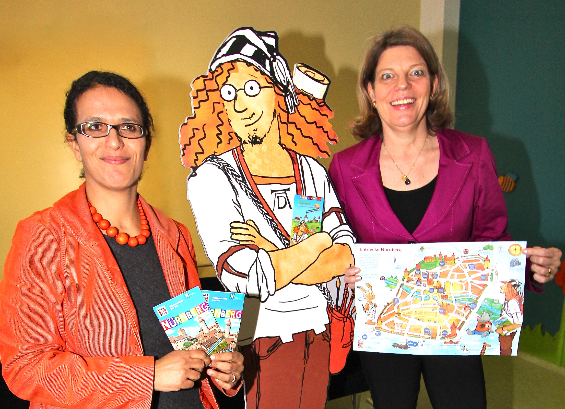 Yvonne Coulin, Städtische Verkehrsdirektorin und CTZ-Geschäftsführerin (r.), und Nicole Hummel vom TESSLOFF Verlag präsentieren gemeinsam mit „Dürer“ kunterbunte Nürnberg-Angebote für Kinder. Foto: John R. Braun