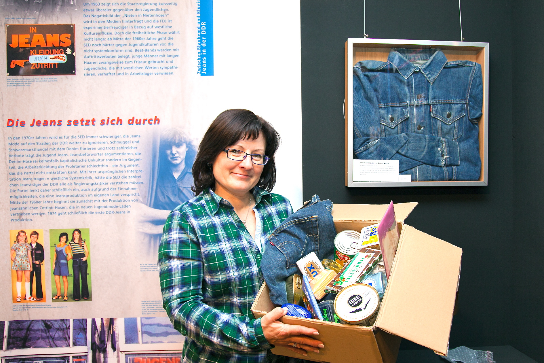Museumsleiterin Tanja Roppelt mit einem nachempfundenen „Westpaket“ aus der Ausstellung. Viele DDR-Bürger wurden so mit Jeanshosen versorgt. Foto: Roland Rosenbauer