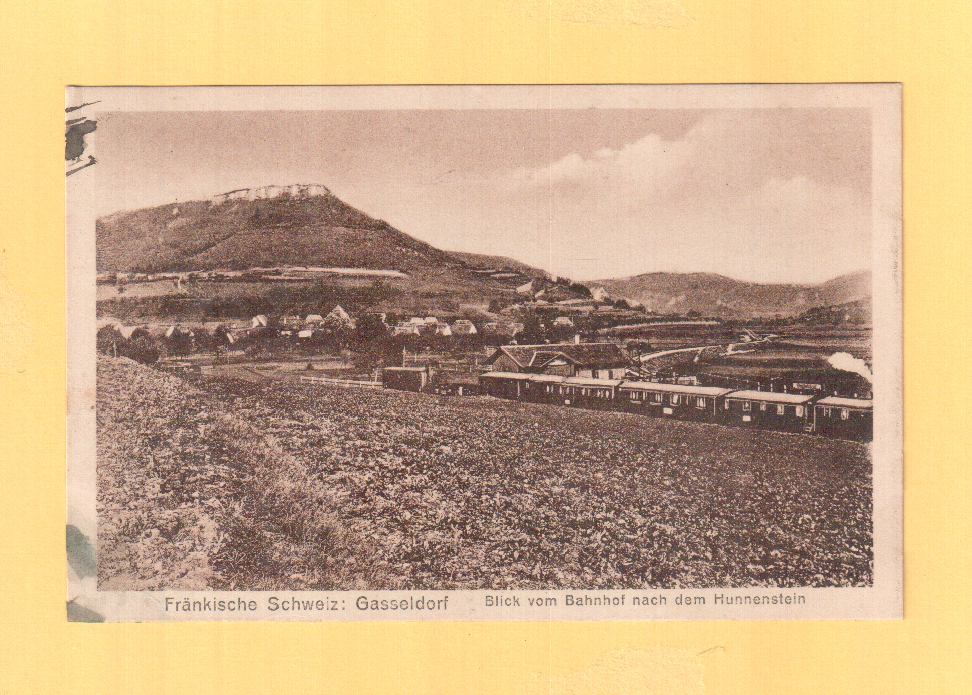 1924 ging diese alte Ansichtskarte von Gasseldorf nach Nürnberg. Wir sehen einen Güterzug mit Personenbeförderung auf der Fahrt nach Ebermannstadt. Hinter dem Bahnhof schwach zu erkennen die 1922 eröffnete Strecke nach
Muggendorf. Sammlung Günther Klebes