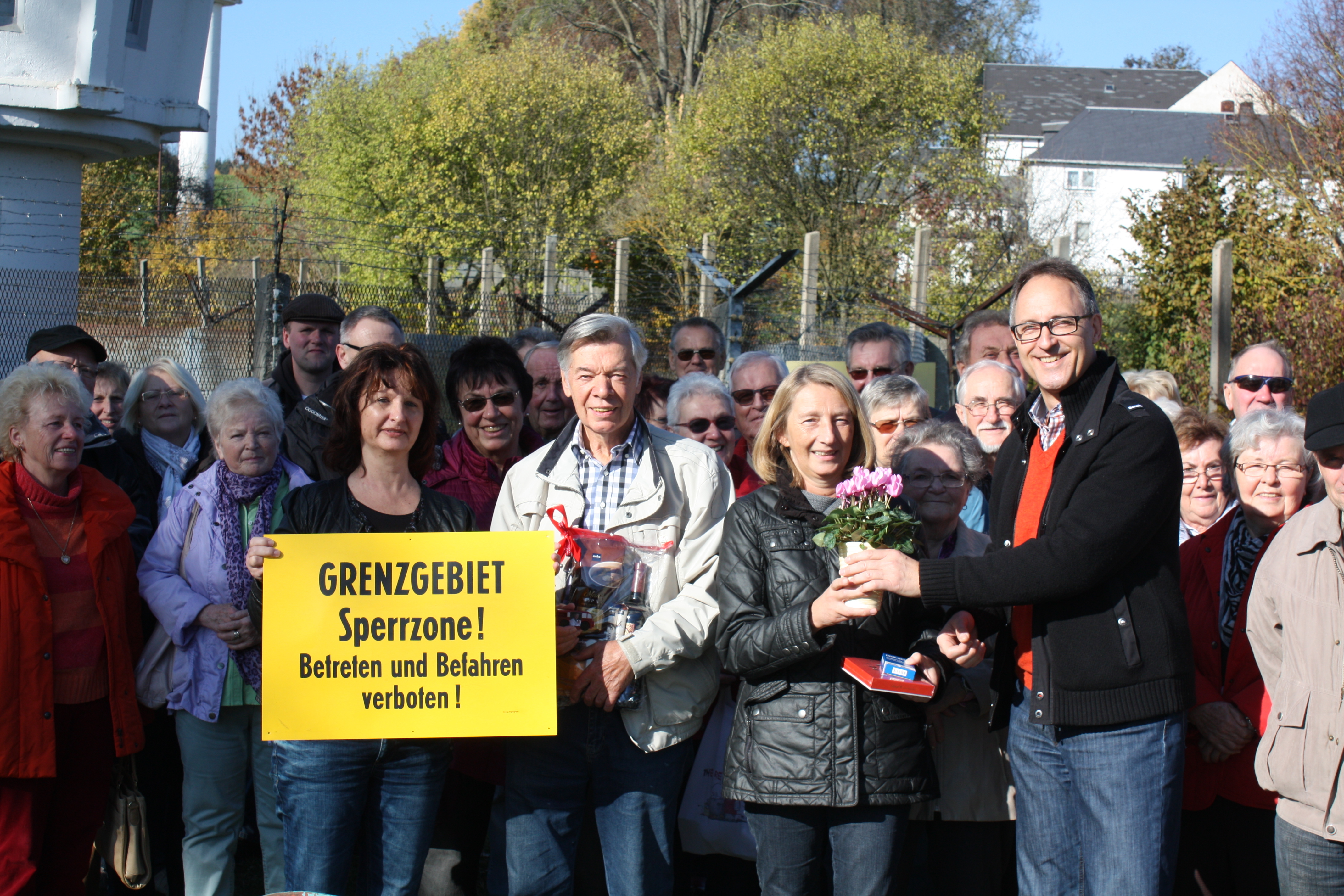 Jürgen Stader von der Stadt Hof überreicht ein kleines Geschenk an die 500. Teilnehmerin der Fahrten, Doris Michler.