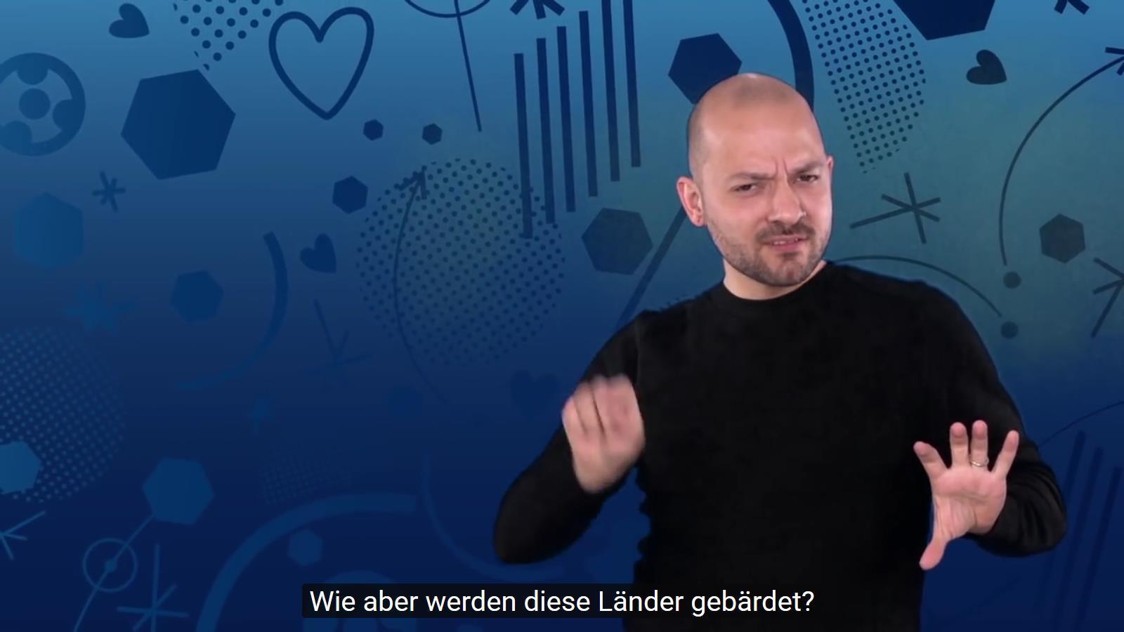 Der gehörlose Gebärdensprachdozent Benedikt J. Sequeira Gerardo zeigt die Gebärden für alle teilnehmenden Nationen.