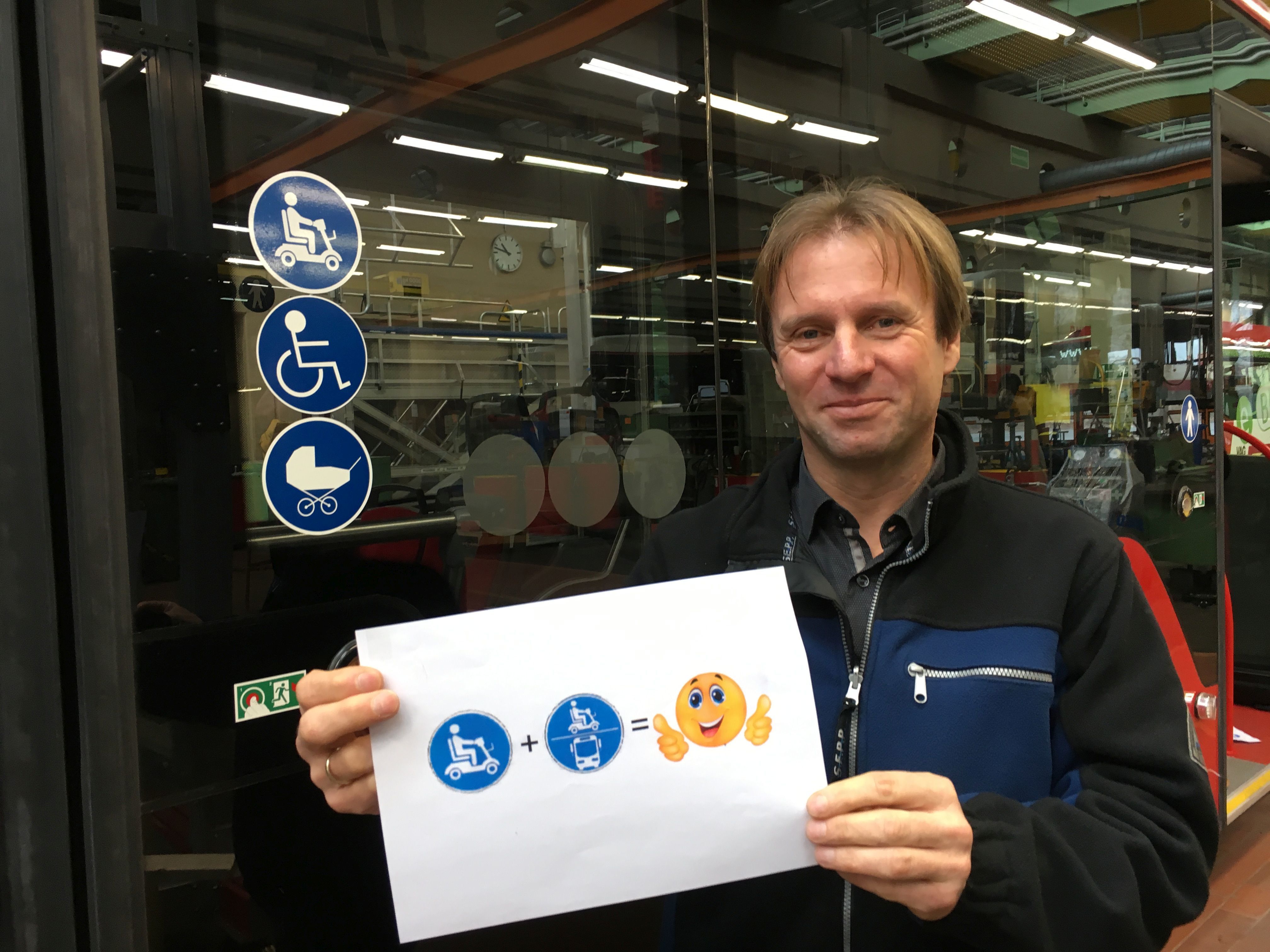 Michael Sievers, Leiter der VAG-Buswerkstatt, zeigt, wie es richtig geht: Treffen die beiden Symbole aufeinander, können E-Scooter-Nutzer in dem Bus mitfahren.