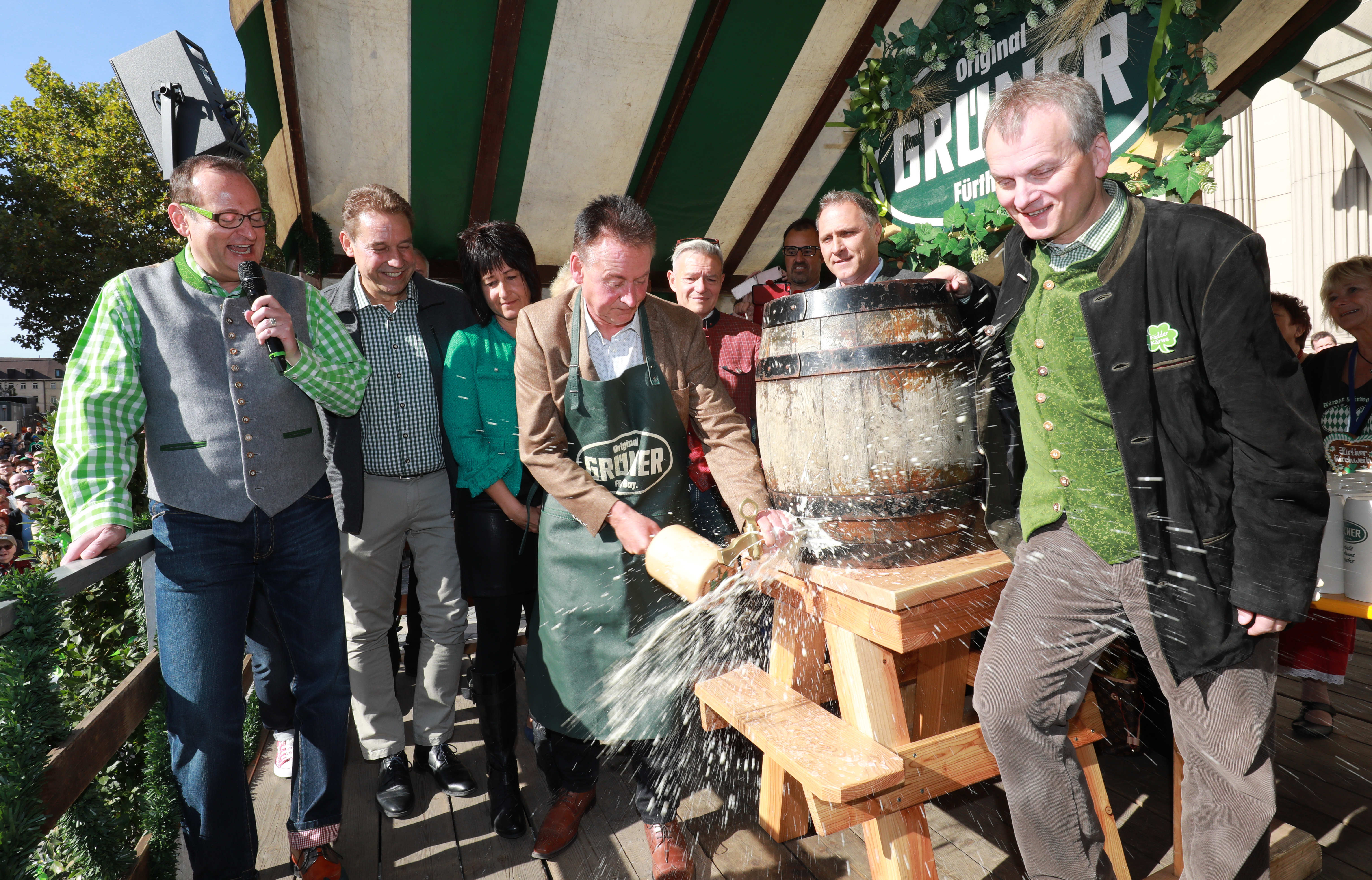 Bierspritzer beim ersten Schlag durch Oberbürgermeister Dr. Thomas Jung mit (v.l.) Moderator Volker Heissmann, Bürgermeister Markus Braun, Heike Jung, Thomas Jung, MdL Horst Arnold und Fürths Wirtschaftsreferent Horst Müller.