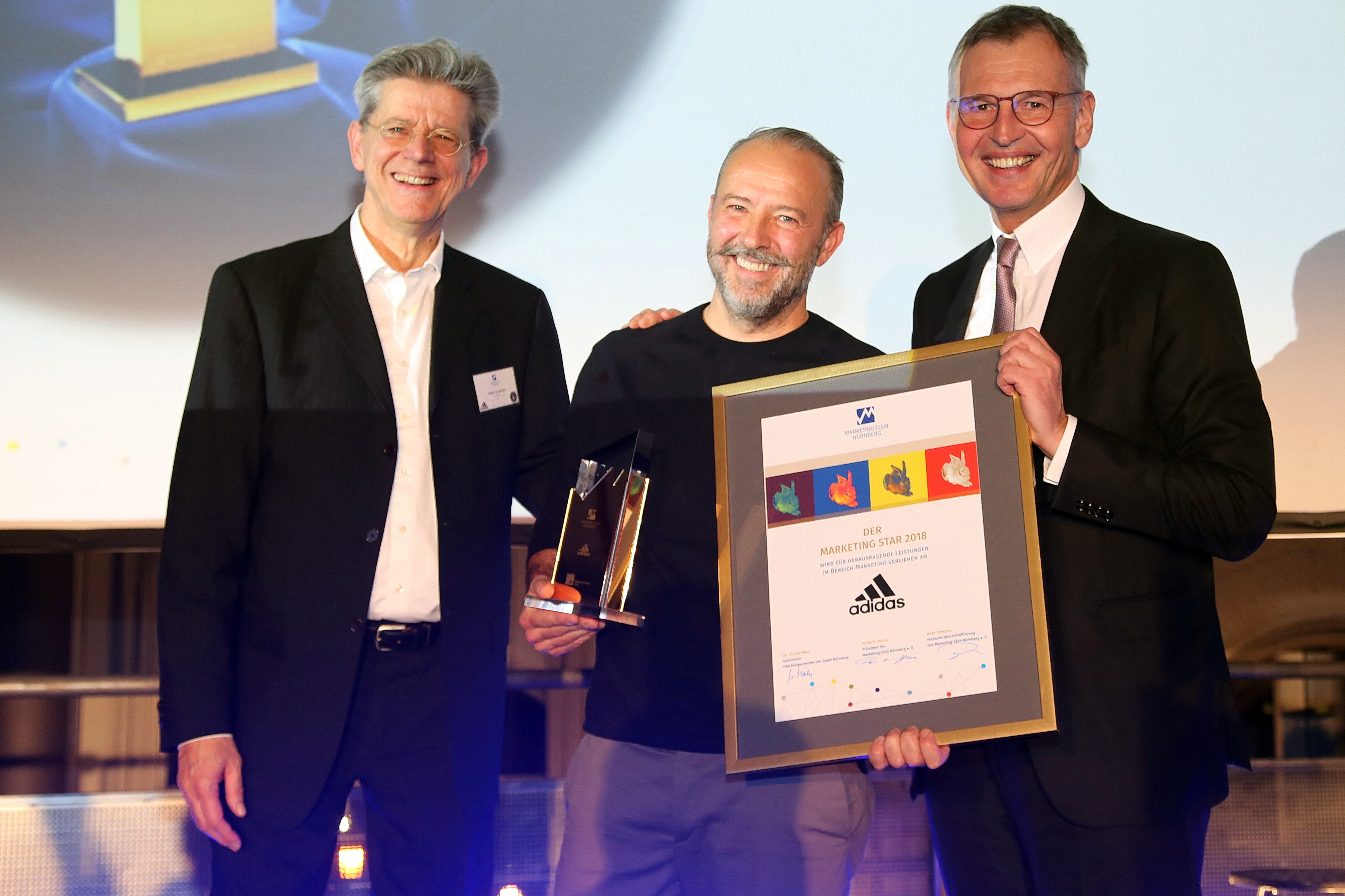 Adidas Global Marketing Direktor Jocelyn Robiot nimmt den Marketing Star aus den Händen von Peter Hache (l., Präsident Marketing Club Nürnberg) und Dirk von Vopelius (Präsident IHK Nürnberg für Mittelfranken, r.) entgegen.