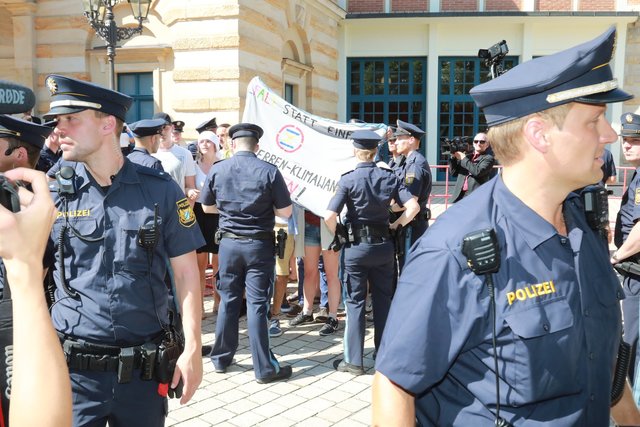 Dutzend junger Frauen und Männer demonstriert gegen den Klimawandel.