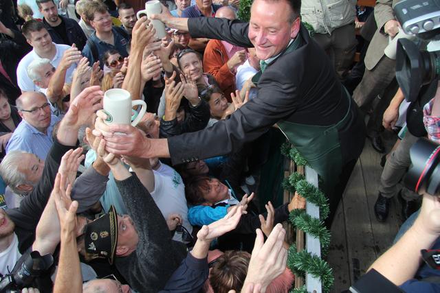 Nach dem Anstich gibt es Freibier für alle: Oberbürgermeister Thomas Jung hat alle Hände voll zu tun, um das Grüner-Bier vom ersten Fass an die Wartenden zu verteilen.