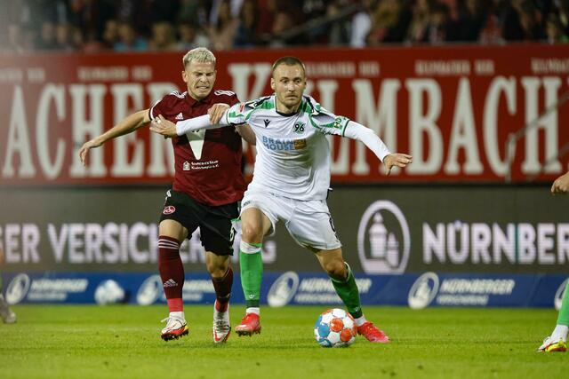 Hannovers Tom Trybull (r) schirmt den Ball vor dem Nürnberger Lino Tempelmann (l) ab.  | Foto: Löb Daniel/dpa