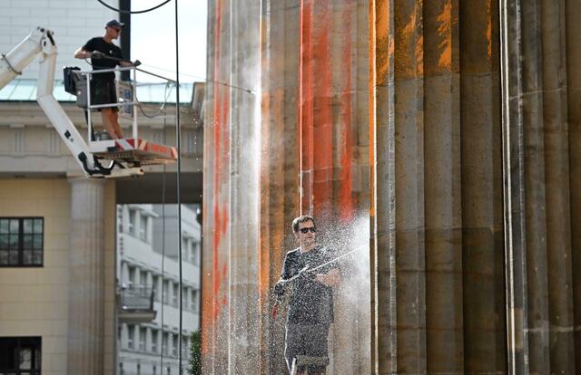 Reinigungsarbeiten nach einem Farbanschlag der so genannten letzten Generation auf das Brandenburger Tor.   | Foto: Britta Pedersen/dpa