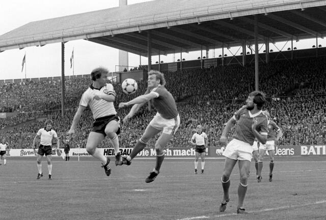 Kaiserslauern: Kopfballduell zwischen Frankfurts Stürmer Bernd Hölzenbein (l) und dem Lauterer Verteidiger Hans-Peter Briegel (M). Eintracht Frankfurt gewinnt am 02.05.1981 vor 71.000 Zuschauern im Stuttgarter Neckarstadion das DFB-Pokalendspiel gegen den 1. FC Kaiserslautern mit 3:1 und sichert sich den Cup damit zum drittenmal. Hölzenbein ist mit 78 Jahren gestorben.  | Foto: Jörg Schmitt/dpa