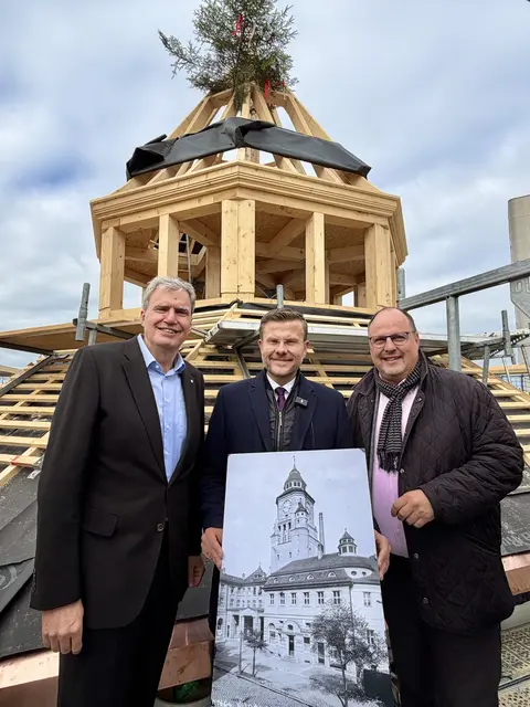 Richtfest auf der Turm-Baustelle des Volksbads am 13. Oktober 2025 (v.l.): Der Geschäftsführer der NürnbergMesse, Peter Ottmann, Nürnbergs Oberbürgermeister Marcus König und Bürgermeister und Erster Werkleiter von NürnbergBad, Christian Vogel, auf der Turmspitze des wiedererrichteten Volksbadturms. | Foto: Agentur OROLO / Stadt Nürnberg