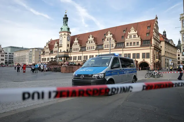Rettungskräfte stehen in der Nähe eines beschädigten Autos an der Stelle, wo ein Auto in eine Menschengruppe gefahren ist. | Foto: Jan Woitas/dpa
