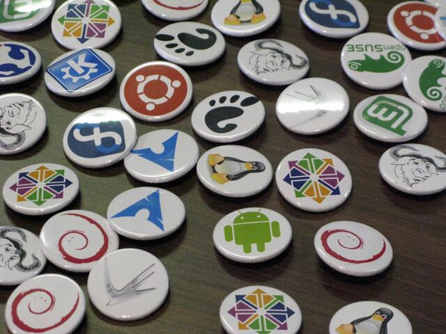 Ein Tisch voll mit Buttons mit den unterschiedlichen Logos verschiedener Linux Versionen. | Foto: LUG Nürnberg